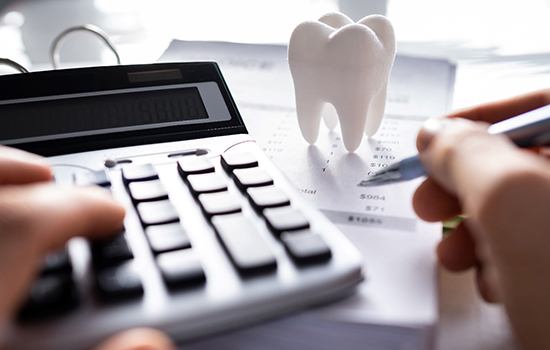 A patient calculating the cost of a dental emergency