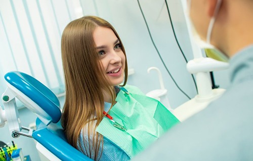 Patient in Shelburne smiling at the dentist, avoiding dental emergencies